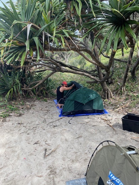 Nurture & Bloom participant setting up camp on an adventure day trip